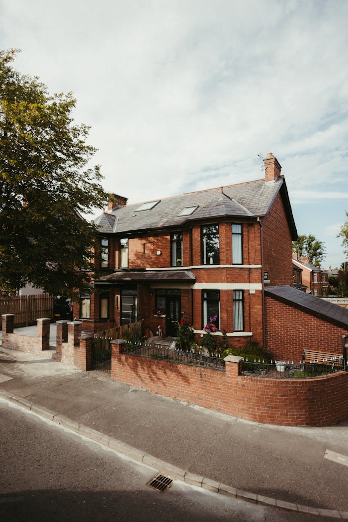 A beautiful red brick house located in a quiet neighborhood in Belfast, Northern Ireland, showcasing classic architecture.